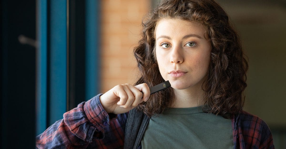 High school girl about to smoke an e-cigarette