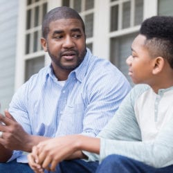 Fathering talking to his son about the dangers of tobacco