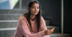 A teen girl holding a vape