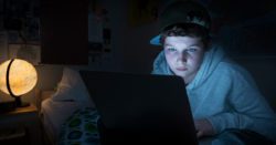 A kid in his room on a laptop