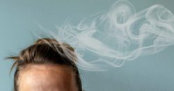 Smoke hovering over a persons head