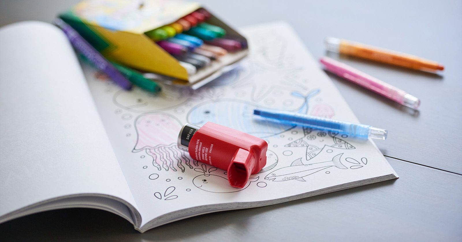 children's coloring book with a inhaler sitting on top