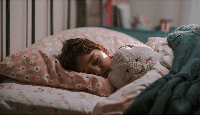 Child asleep in bed with cloud stuffy