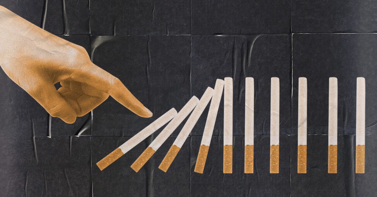 Person knocking down cigarettes stacked like dominos